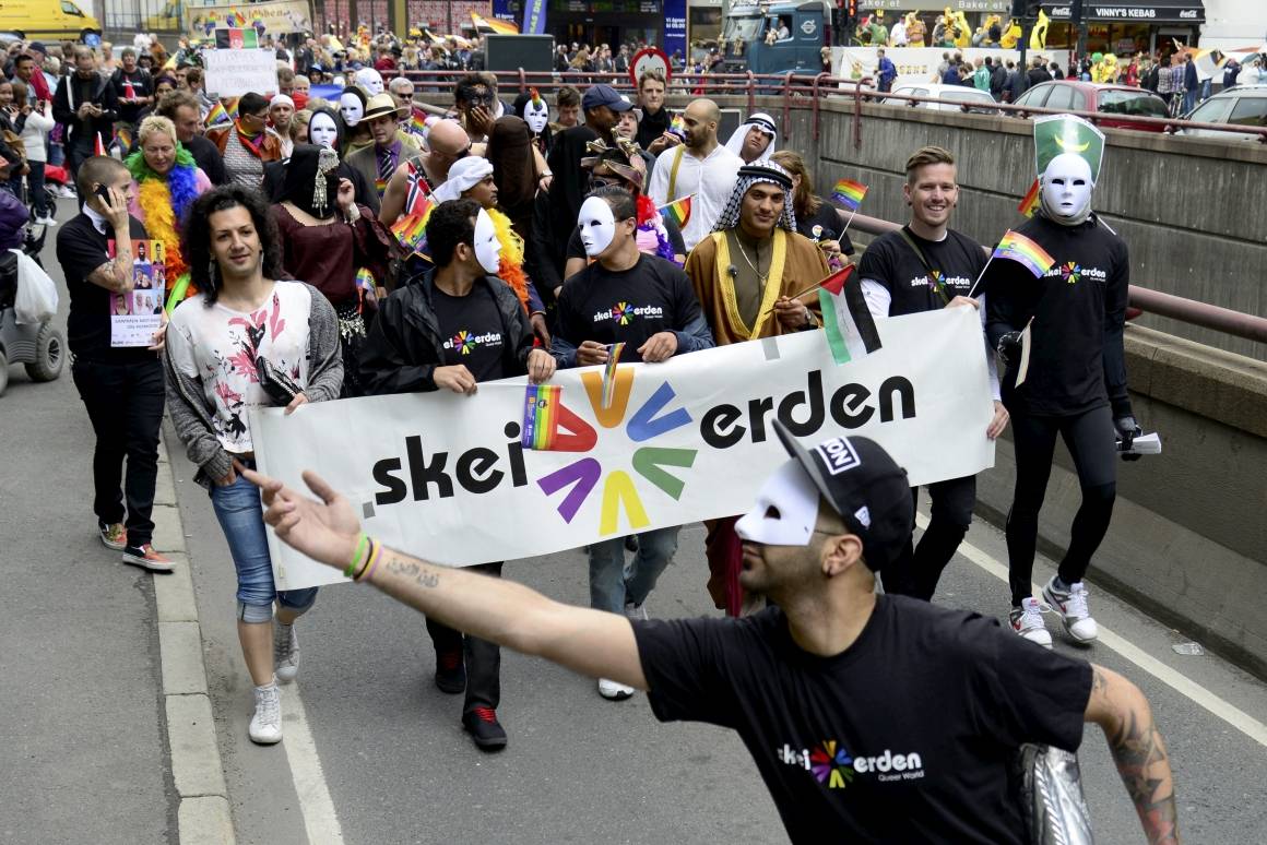 Bildet er tatt under Pride-paraden i Oslo, og viser medlemmer av Skeiv Verden - en organisasjon for LHBTIQ-personer med minoritetsbakgrunn. Flere av dem bærer masker for å skjule sin identitet. Foto: Per Løchen/NTB Scanpix